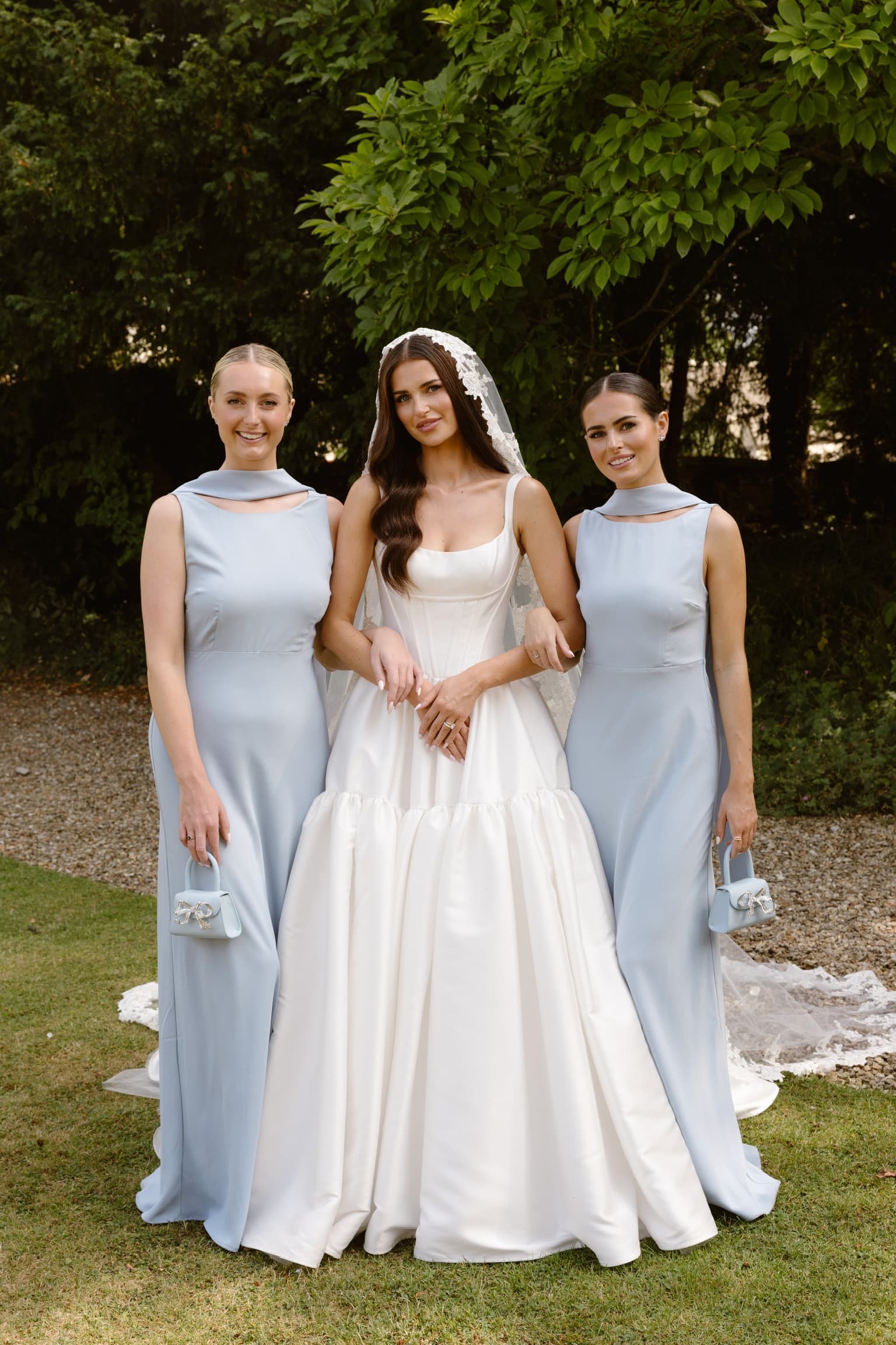 Bride and bridesmaids in pale blue gowns